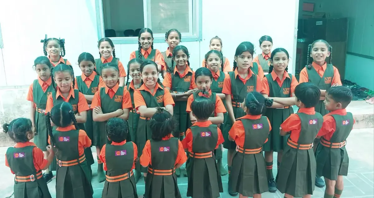 Schoolchildren in uniform standing together in a classroom