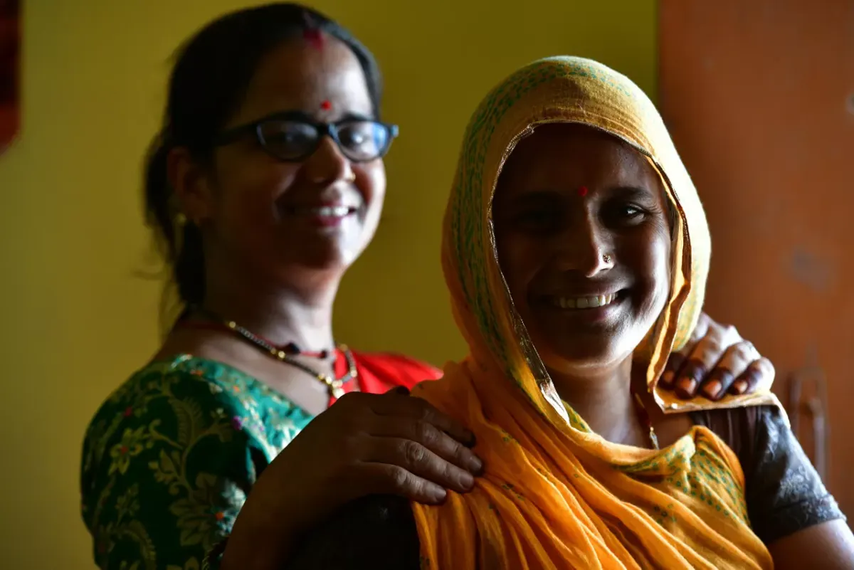 Two women from a community supported by AU Foundation